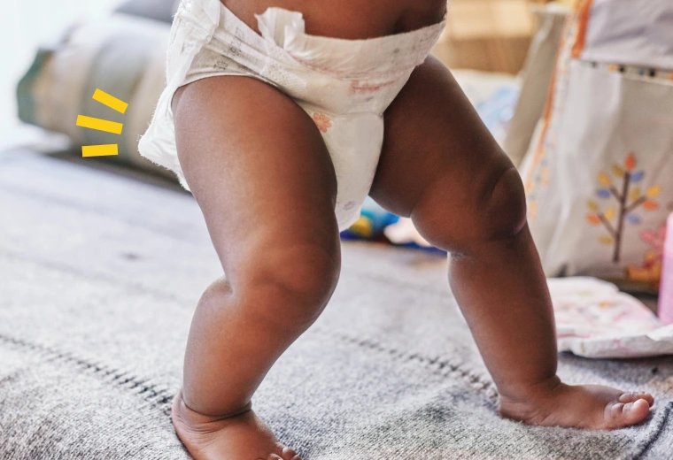 a baby with a diaper walking