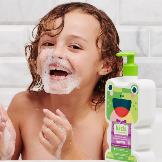child in bath tub with bubbles on nose