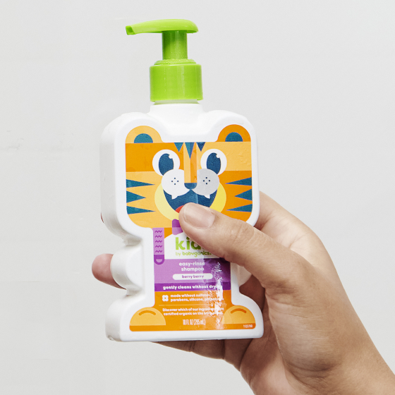 kids easy-rinse shampoo tiger shaped bottle in adult hand